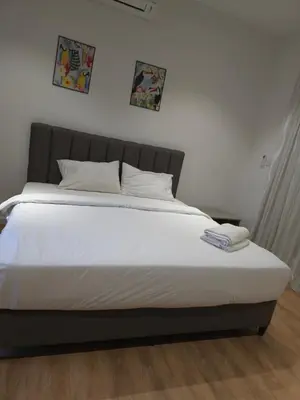 a large bed with white sheets and pillows on it at Quill Residence KL Suites in Kuala Lumpur