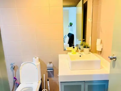 a bathroom with a sink and a toilet and a mirror at Mercu Summer Suites KLCC By Suite Apartment in Kuala Lumpur