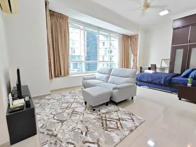 a living room with a couch and a chair and a tv at Parkview Serviced Apartment Kuala Lumpur Twin Tower in Kuala Lumpur