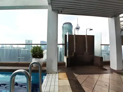 a balcony with a pool and a view of the city at Parkview Serviced Apartment Kuala Lumpur Twin Tower in Kuala Lumpur