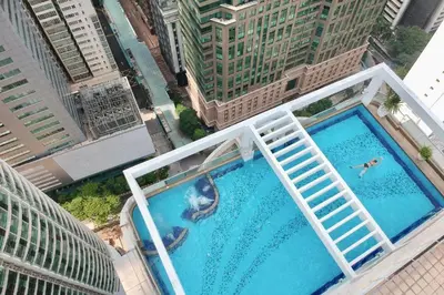 an overhead view of two people swimming in a pool on a building at Parkview Serviced Apartment Kuala Lumpur Twin Tower in Kuala Lumpur