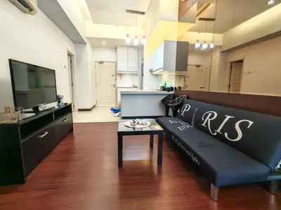 a living room with a black couch and a table at Parkview Serviced Apartment Kuala Lumpur Twin Tower in Kuala Lumpur