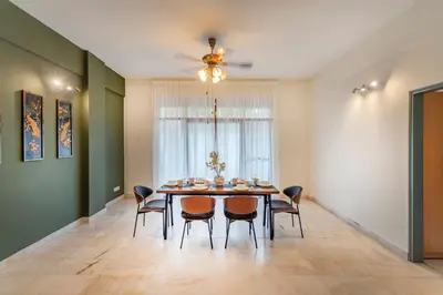 a dining room with a table and chairs at Embassy Villa by Cobnb at Ampang Hilir in Kuala Lumpur