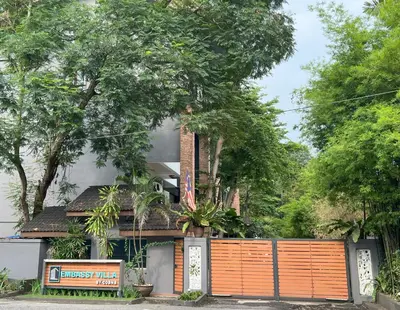 a house with an orange gate in front of it at Embassy Villa by Cobnb at Ampang Hilir in Kuala Lumpur