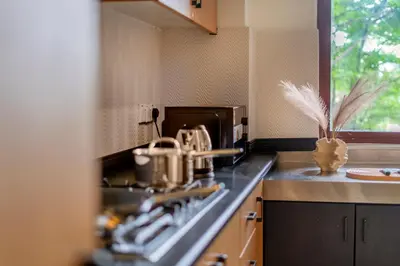 a kitchen with a stove with pots and pans at Embassy Villa by Cobnb at Ampang Hilir in Kuala Lumpur