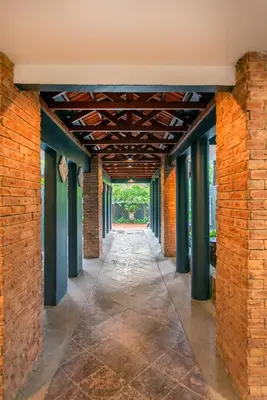 an empty hallway in a building with a brick wall at Embassy Villa by Cobnb at Ampang Hilir in Kuala Lumpur
