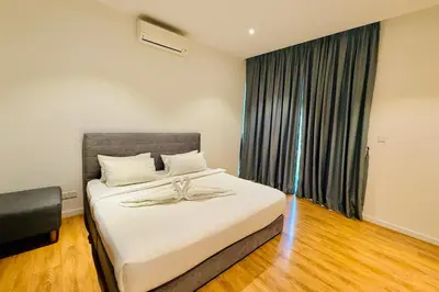 a bedroom with a bed and a large window at Majestic Suites KLCC in Kuala Lumpur