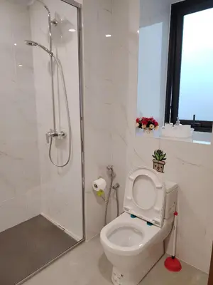 a white bathroom with a shower and a toilet at Agile Residence Dual-Key Gem Bukit Bintang by Natol Chain of Homestays in Kuala Lumpur