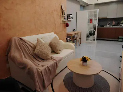 a living room with a white couch and a table at Agile Residence Dual-Key Gem Bukit Bintang by Natol Chain of Homestays in Kuala Lumpur