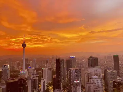 a view of a city skyline at sunset at M Vertica Cheras KL City Fully Air-Con Nice View Home in Kuala Lumpur
