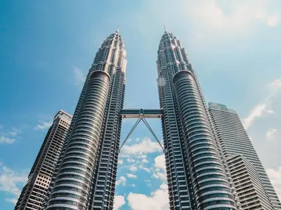 two tall skyscrapers in the middle of a city at M Vertica Cheras KL City Fully Air-Con Nice View Home in Kuala Lumpur