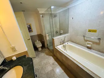 a bathroom with a shower and a tub and a toilet at PERFECT SUITE at TIMES SQUARE KL in Kuala Lumpur