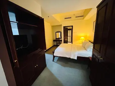 a bedroom with a bed and a tv in it at PERFECT SUITE at TIMES SQUARE KL in Kuala Lumpur