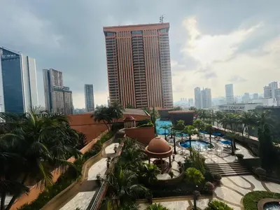 a view of a resort with a pool and a tall building at PERFECT SUITE at TIMES SQUARE KL in Kuala Lumpur