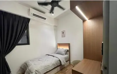 a bedroom with a bed and a ceiling fan at Cozy Room in Kuala Lumpur