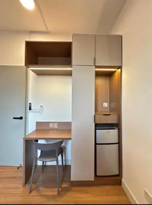a small kitchen with a table and a chair at Cozy Room in Kuala Lumpur