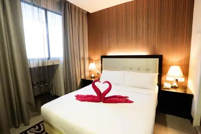 a hotel room with a red towel on a bed at The Grand Campbell Hotel Kuala Lumpur in Kuala Lumpur