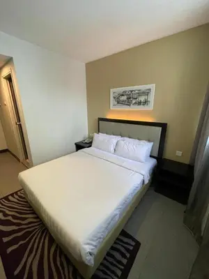 a bedroom with a large white bed in a room at The Grand Campbell Hotel Kuala Lumpur in Kuala Lumpur