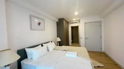 a bedroom with a large bed with white sheets at The Atrium at Jalan Ampang by OKBnB - Classy Executive Family Suite 3Bedroom with Balcony , nearby KLCC in Kuala Lumpur