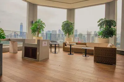 a large room with furniture and potted plants in a building at The Atrium at Jalan Ampang by OKBnB - Classy Executive Family Suite 3Bedroom with Balcony , nearby KLCC in Kuala Lumpur