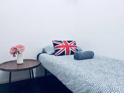 a room with a bed and a table with a vase of flowers at Arcoris SOHO by Cj in Kuala Lumpur