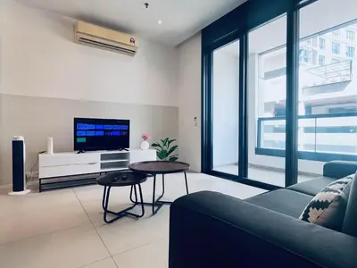 a living room with a couch and a tv at Arcoris SOHO by Cj in Kuala Lumpur