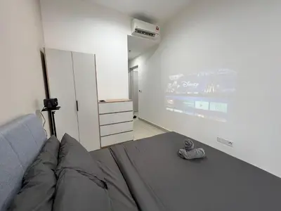 a bedroom with a bed and a wall with a projector at Trion KL By Luxe Home in Kuala Lumpur