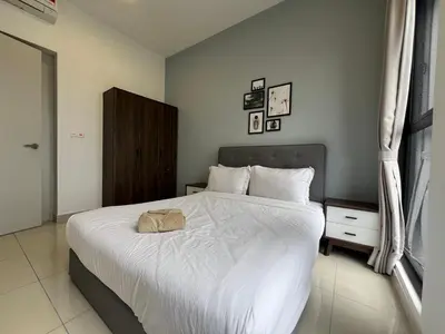 a bedroom with a large bed with white sheets at Trion KL By Luxe Home in Kuala Lumpur