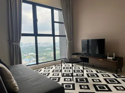 a living room with a tv and a large window at Trion KL By Luxe Home in Kuala Lumpur