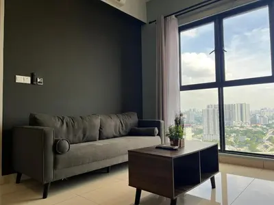 a living room with a couch and a large window at Trion KL By Luxe Home in Kuala Lumpur