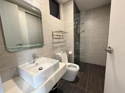 a white bathroom with a sink and a toilet at Trion KL By Luxe Home in Kuala Lumpur