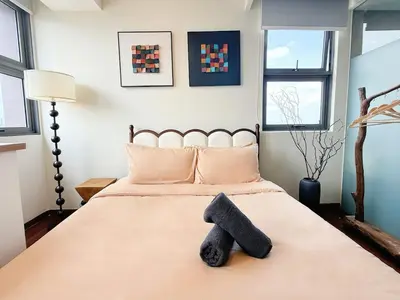 a bedroom with a bed with a black towel on it at Cozy Studio l Riveria City l 1km to KL Sentral in Kuala Lumpur