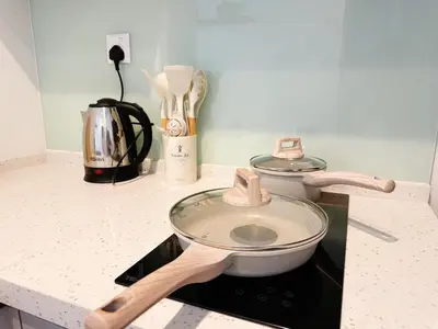 a kitchen counter with a strainer and a pan on a stove at Cozy Studio l Riveria City l 1km to KL Sentral in Kuala Lumpur