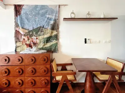 a dining room with a table and a wooden table and chairs at Cozy Studio l Riveria City l 1km to KL Sentral in Kuala Lumpur