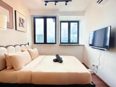 a living room with a couch and a flat screen tv at Cozy Studio l Riveria City l 1km to KL Sentral in Kuala Lumpur