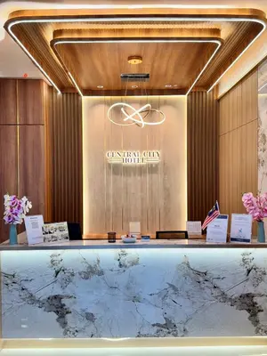 a lobby with a reception desk with a marble counter at Central City Hotel at Chinatown in Kuala Lumpur