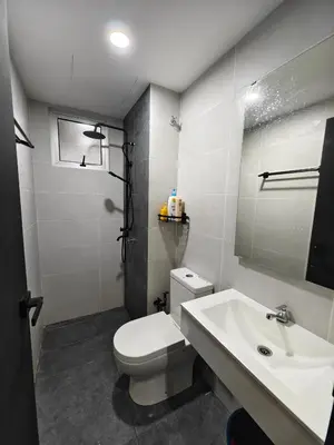 a bathroom with a white toilet and a sink at Aiman Damia Homestay in Kuala Lumpur