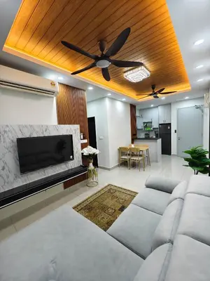 a living room with a couch and a ceiling fan at Aiman Damia Homestay in Kuala Lumpur