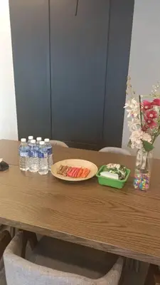 a table with a plate of food and bottles of water at Star Residence Klcc By Stellar Inn in Kuala Lumpur