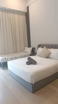two beds in a hotel room with at Star Residence Klcc By Stellar Inn in Kuala Lumpur