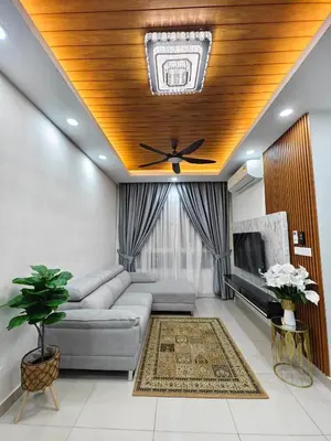 a living room with a couch and a ceiling fan at AimanDamia Homestay Setapak II in Kuala Lumpur