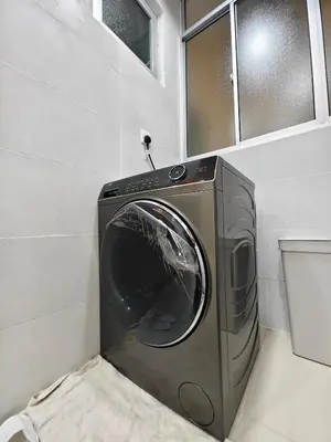 a washing machine in a corner of a room at AimanDamia Homestay Setapak II in Kuala Lumpur