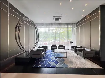 a living room with a large mirror and chairs at Opus Residence by Cloud Escape in Kuala Lumpur