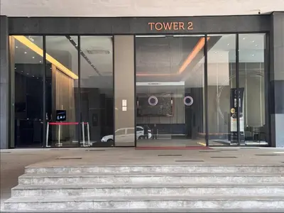 a glass entrance to a building with stairs in front at Opus Residence by Cloud Escape in Kuala Lumpur