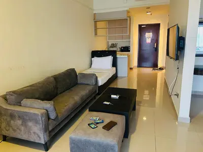 a living room with a couch and a bed at Times square at suite kl in Kuala Lumpur