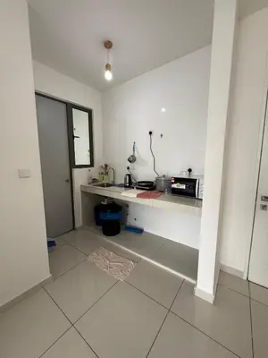 a white kitchen with a counter and a microwave at Cozy kenwingston platz kl 2-5pax 2BR&2BR Klcc view with free parkin 4305 in Kuala Lumpur