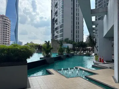 a pool of water with a fountain in a city at SG Residence by Lush Living in Kuala Lumpur