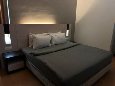 a bed with two pillows on it in a room at SG Residence by Lush Living in Kuala Lumpur