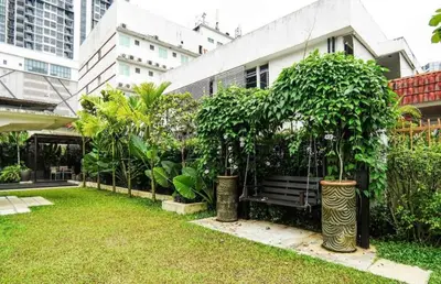 a park with a bench and trees and buildings at 68 Palms 01 l Midvalley l KL Sentral l 5 Pax in Kuala Lumpur