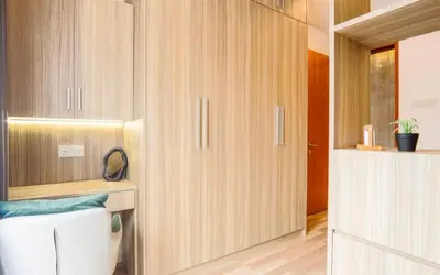 a bathroom with wooden cabinets and a toilet at 68 Palms 01 l Midvalley l KL Sentral l 5 Pax in Kuala Lumpur